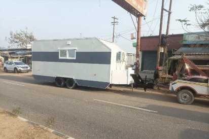 Double-axle caravan trailer parked on the roadside
