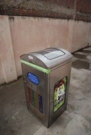 Smart dustbin against a wall, three-quarter view